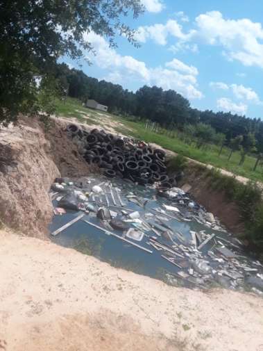 Trash in Ditches at Colony Ridge's Terrenos Houston